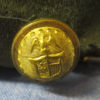 Side gold button of the cap close look