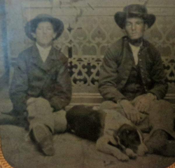 Old photo of a two soldier with a dog