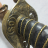 Sword handle with engraved letters