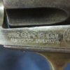 Below revolver's cylinder, close look of the letters and numbers carved