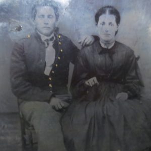 Black and white photo of a man and woman sitting beside together