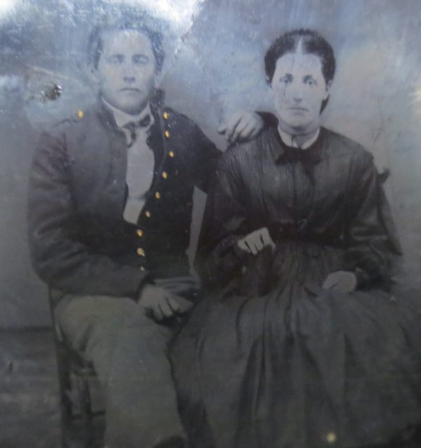 Black and white photo of a man and woman sitting beside together