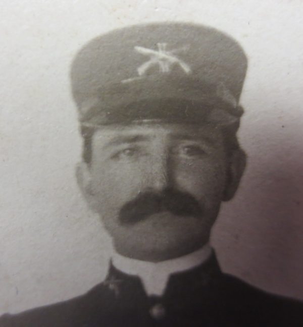 Man's face with mustache and wearing cap