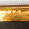 Edge of a picture frame with gold finish