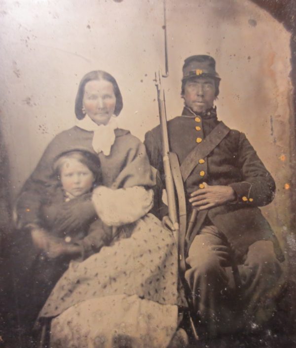 Picture of a war veteran with wife and child