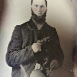 Old picture of a man holding a gun