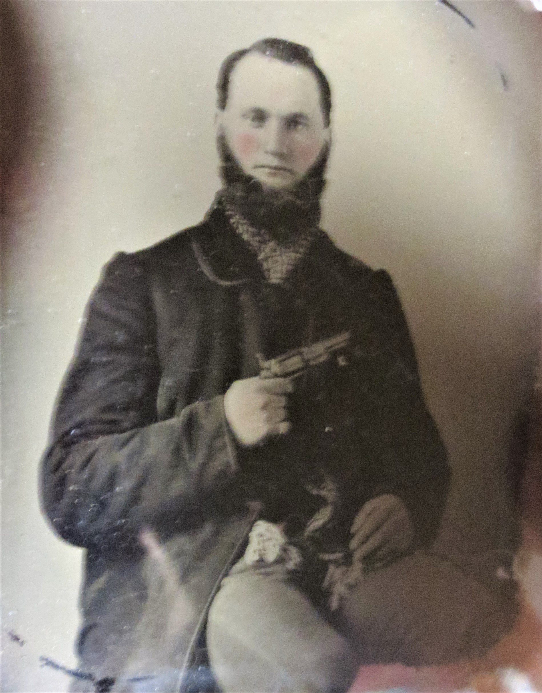Old picture of a man holding a gun