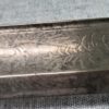 Zoomed in blade of the sword with carved patterns