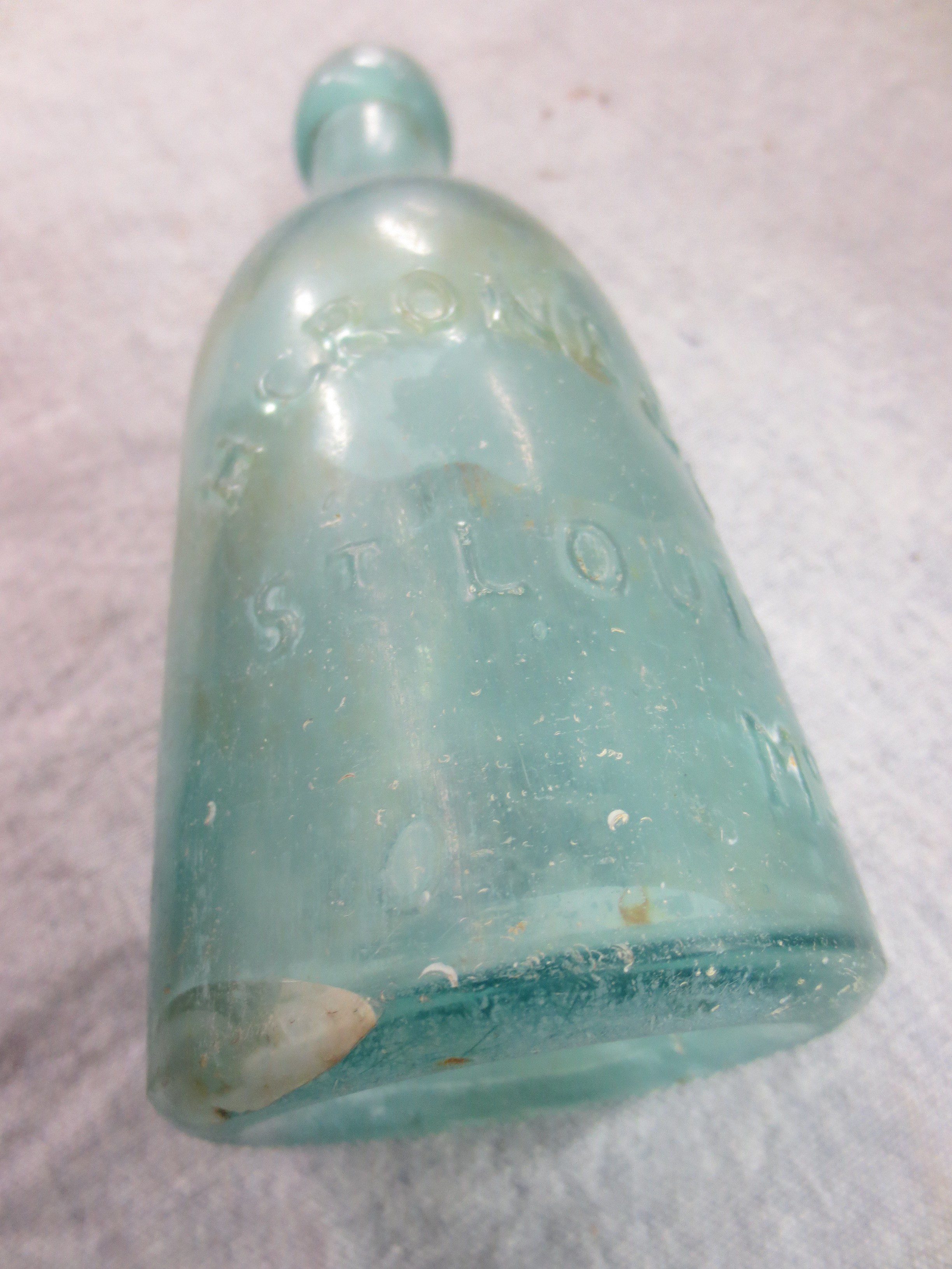 Old aqua soda water bottle