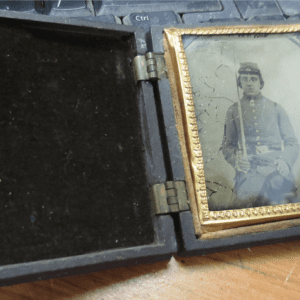 Opened case containing a frame of soldier's photo holding sword