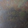 Rusty shovel carved with "Ames 1945" close look